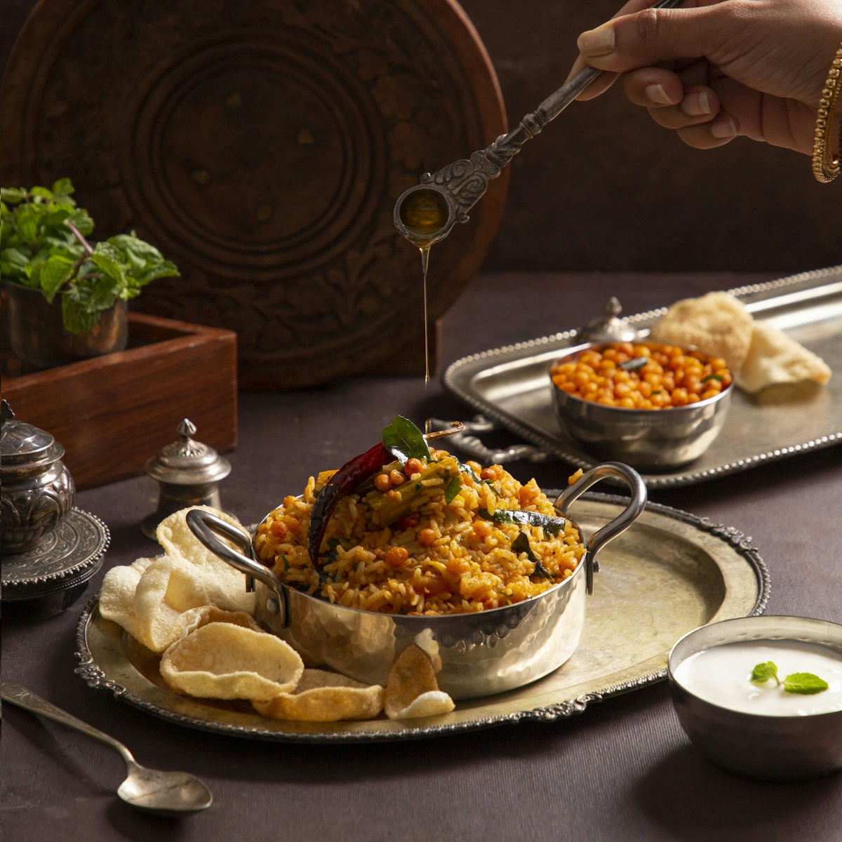 A person holding a spoon over a bowl of food