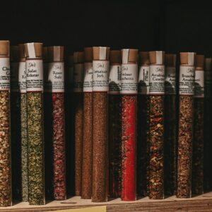 a shelf filled with lots of different types of spices