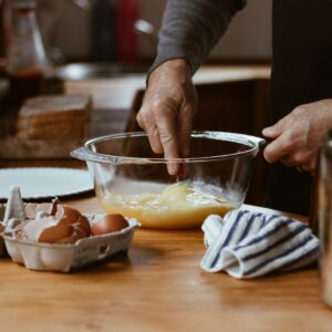person holding clear glass bowl with brown liquid